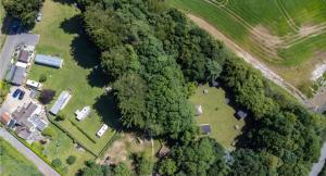 an aerial view of a park with trees and a field at Snowdrop Cabin Retreat dog friendly peaceful in Huttoft +18 photos