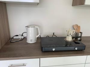 a kitchen counter with a coffee maker and a blender at Sunset Velence Villa in Velence