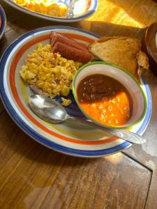a plate of food with a bowl of soup and bread at Velero Heaven in Rio Dulce +14 photos