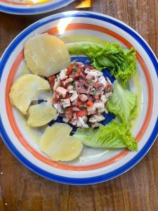 a plate of food with meat and lettuce on a table at Velero Heaven in Rio Dulce