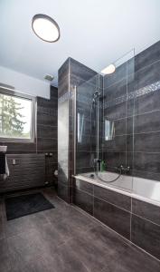 a bathroom with a tub and a glass shower at The Loft sleeps 4 in Bridel