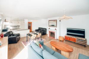 a living room with a blue couch and a table at The Loft sleeps 4 in Bridel