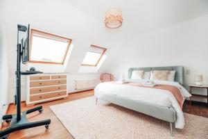 a bedroom with a bed and a dresser and a mirror at The Loft sleeps 4 in Bridel