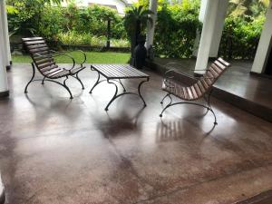 two chairs and a table on a patio at Katys Lodge in Ja-Ela +1 photo
