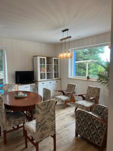 a dining room with a table and chairs at Blue cottage near Krakow in Rudawa