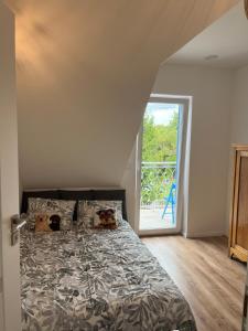 a bedroom with a bed with two dogs laying on it at Blue cottage near Krakow in Rudawa
