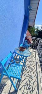 a blue table and chair sitting on a patio at Blue cottage near Krakow in Rudawa +11 photos