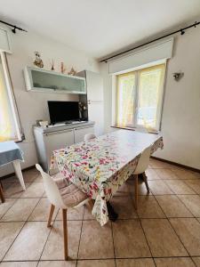 a dining room with a table and chairs at Appartamento Margherita in Transacqua +11 photos