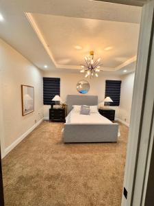 a large bedroom with a bed and a chandelier at Waterfront Resort Escape in Roscoe +13 photos