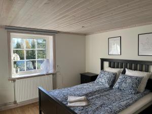 a bedroom with a bed and a window at Solhem Terrassen in Arvika