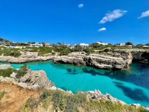 a view of a cove with blue water at SA CALETA - Apartamento con piscina y junto a la playa in Cala en Blanes
