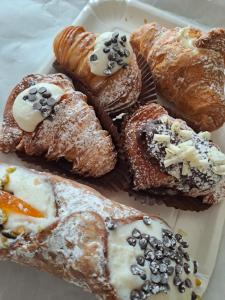 a white plate of pastries on a table at ANGELA Rooms in Marineo