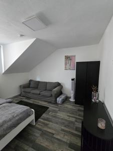 a living room with a couch and a bed at Ferienwohnung Monteurzimmer in Eppelborn