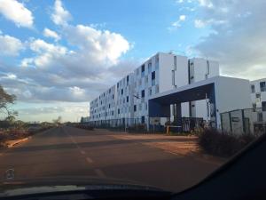 a large white building on the side of a road at Tatu Nest in Tatu City
