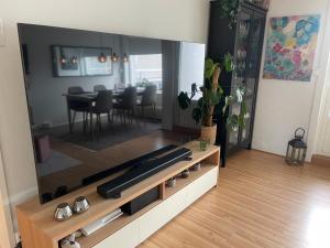a living room with a large entertainment center with a tv at Your own room- 48 h free parking in Lillestrøm