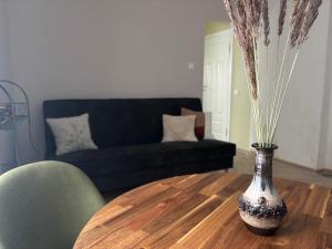 a living room with a vase on a wooden table at The 7th Apartment in Cēsis