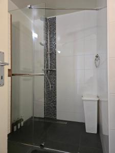 a shower with a glass door in a bathroom at Studio Cosy à Crans-Montana in Crans-Montana +12 photos