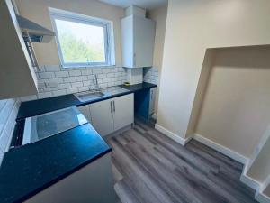 a small kitchen with a sink and a counter top at The Central Hub Luton A in Luton