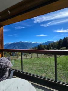 a view from the balcony of a house with a mountain view at Studio Cosy à Crans-Montana in Crans-Montana
