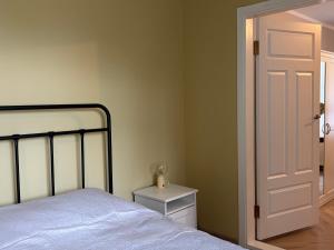 a bedroom with a bed and a white door at The 7th Apartment in Cēsis +4 photos