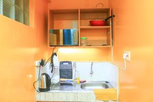a kitchen counter with a sink and a microwave at SpeedwayHaven, 2Mins TO SpurMall & Ashaki Resort 1750 or 1850 or 2000kes in Ruiru