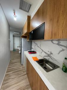 eine Küche mit Spüle und Arbeitsplatte in der Unterkunft The Urban Loft Podomoro City Medan in Medan