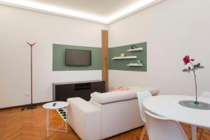 Una sala de estar con un sofá blanco y una mesa. en Monti 29 - Corso Sempione Milano, en Milán