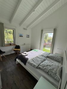 a bedroom with a large bed and a window at Ferienhaus Auszeit mit Sauna in Schwarz