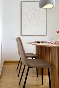 a dining room with a table and a chair at Canaryislandshost l Orilla in Famara +36 photos