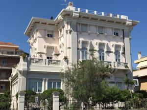 a white building with a tree in front of it at Attico vista mare in Pescara