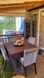 a table and chairs with a plate of food on it at Mobilhome Montourey 4 étoiles 3 chambres 2 salles de bain in Fréjus