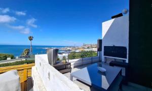 a living room with a view of the ocean at La Santos Beach view Villa with 3 Bed , 3 Bath, Jacuzzi, Sea view in Mossel Bay