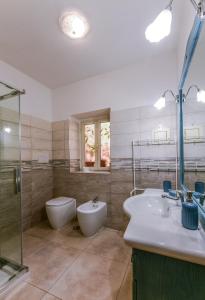 a bathroom with a sink and a toilet and a shower at La Dimora del Porto in Civitavecchia