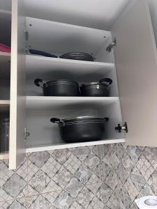 een voorraadkast met twee potten op planken bij Cloud9 suites - Westlands Road in Nairobi