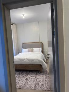 een slaapkamer met een bed en een deur naar een kamer bij Cloud9 suites - Westlands Road in Nairobi