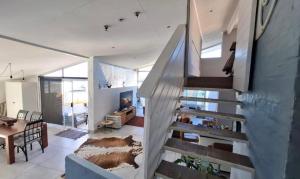 a staircase in a house with a living room at La Santos Beach view Villa with 3 Bed , 3 Bath, Jacuzzi, Sea view in Mossel Bay