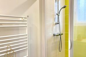 a bathroom with a shower and a glass door at Le Baron du Marais - Élégant et central in Roanne