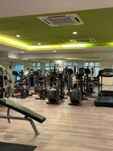 a gym with a lot of treadmills and machines at Apartment in Kulai Bandar Putra in Kulai