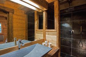 a bathroom with a sink and a shower in a cabin at Amour de Chalet Cabane in La Bresse