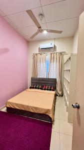 a bedroom with a bed and a ceiling fan at Homestay in Shah Alam