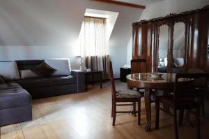 a living room with a table and a couch at FORREST in Polanica-Zdrój