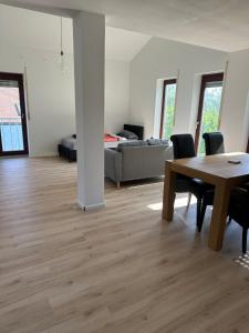 a living room with a table and a couch at Apartment Lyvia - Platz und Ruhe für 5 in Karsau