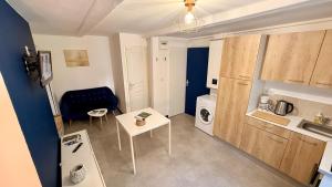 a small living room with a couch and a table at Les Cimes au cœur du Massif du Sancy in Le Mont-Dore