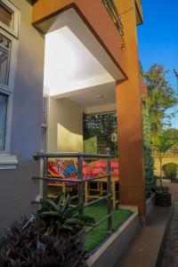 a balcony of a house with a couch on it at Pineapple Apartments in Jinja