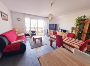 a living room with a couch and a table at Spacious apartment in Juvignac in Juvignac