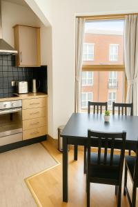 a kitchen and dining room with a table and chairs at Guinness and Grafton city stay in Dublin
