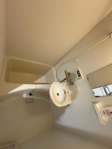 a bathroom with a sink and a toilet at フィフティーフォージャーニー新宿戸山 in Tokyo +33 photos