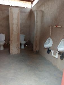 a bathroom with two toilets and two sinks at Chirundu Riverside Campsite in Chirundu +36 photos