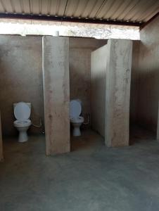 a bathroom with two toilets in a room at Chirundu Riverside Campsite in Chirundu