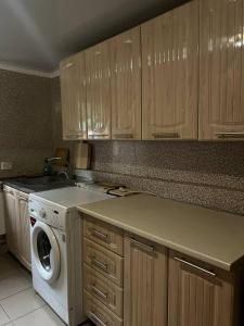 a kitchen with a washer and a washing machine at Дім-Садиба Озерел in Krasna